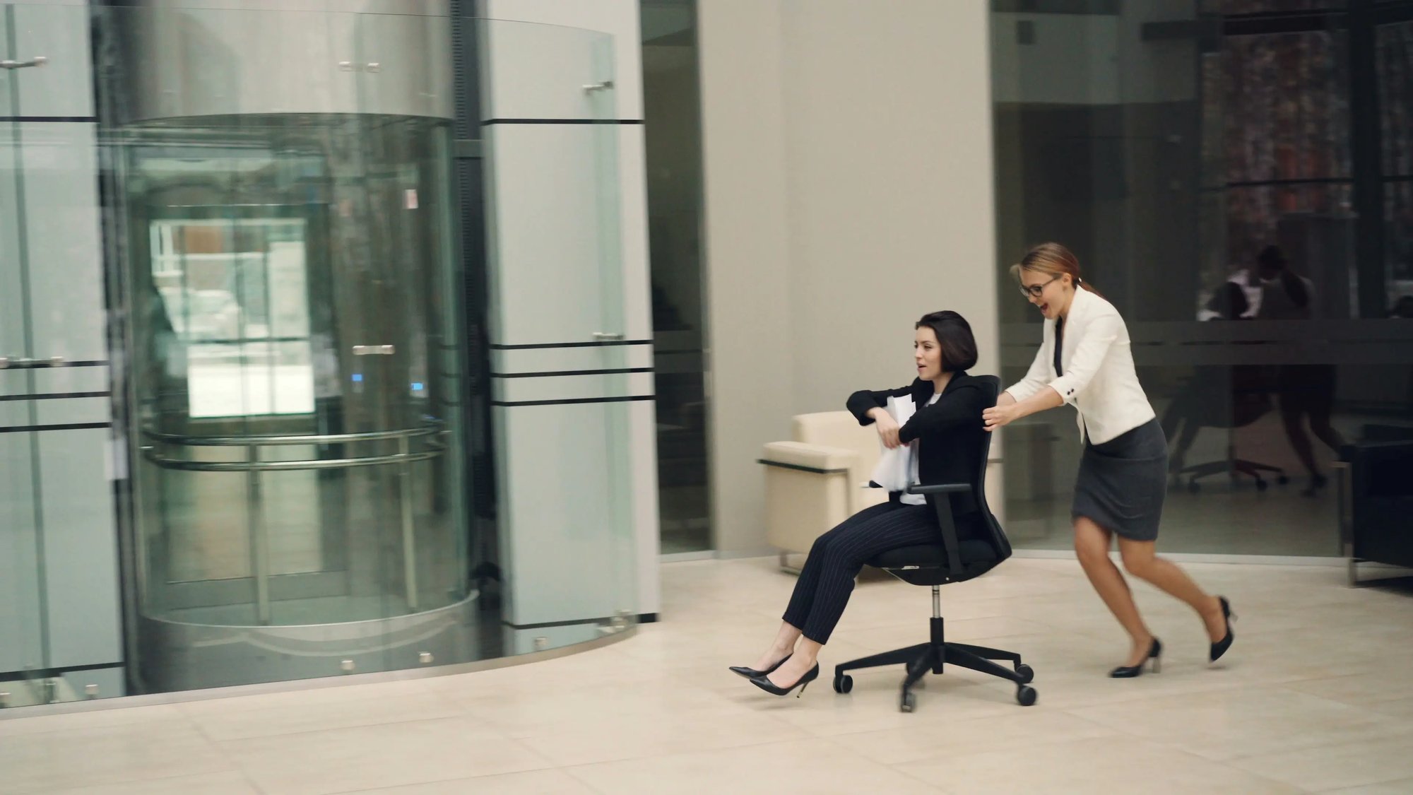 Workplace play running and fun with office chair